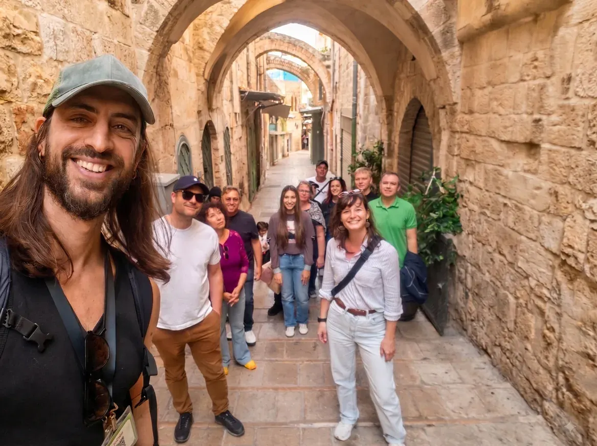 Walking through the arched alleys of Jerusalem's Old City with a group