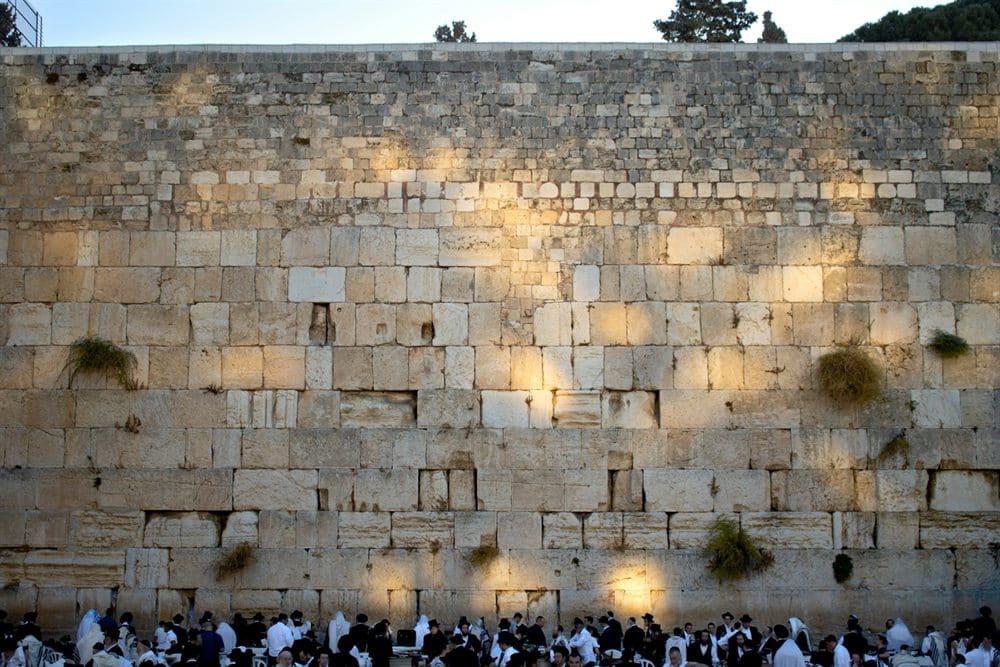 People praying at the Western Wall shortly after sunrise