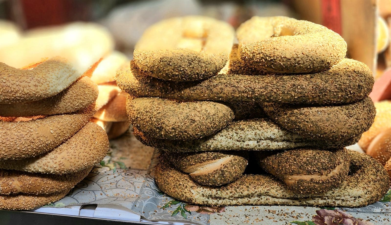 Stacked bagels and bread at a Carmel Market stall